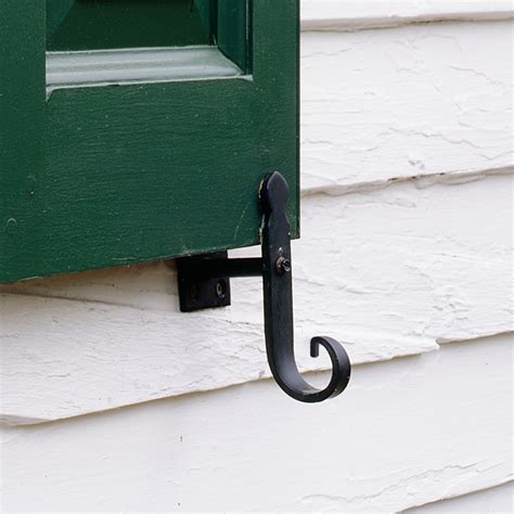 house with shutters with metal tieback|tieback positioning for shutters.